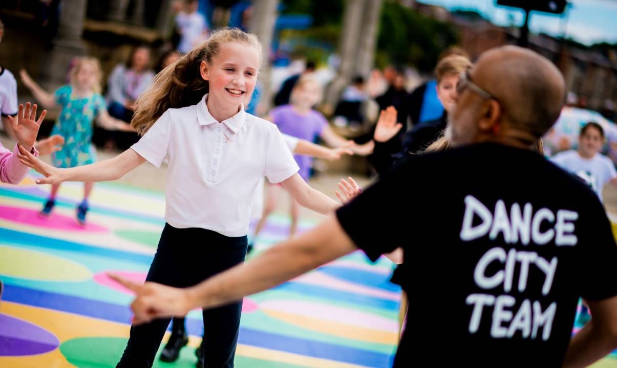 A Dance City instructor leading a dance class for kids on Newcastle’s Quayside