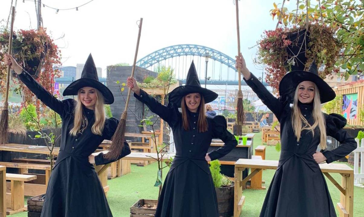 Three women dressed as witches and wizards on Newcastle’s Quayside
